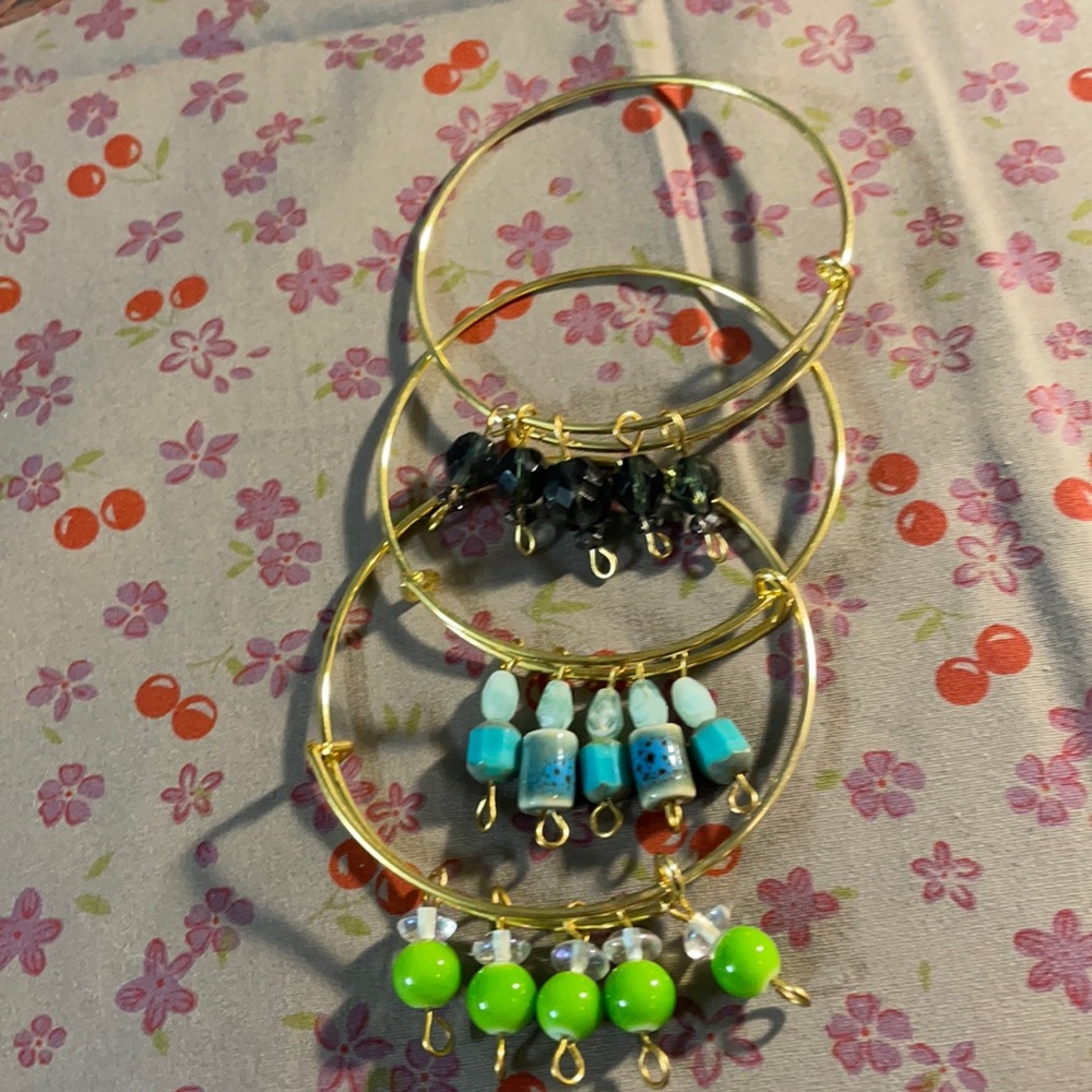 3 charm bracelets in gold.